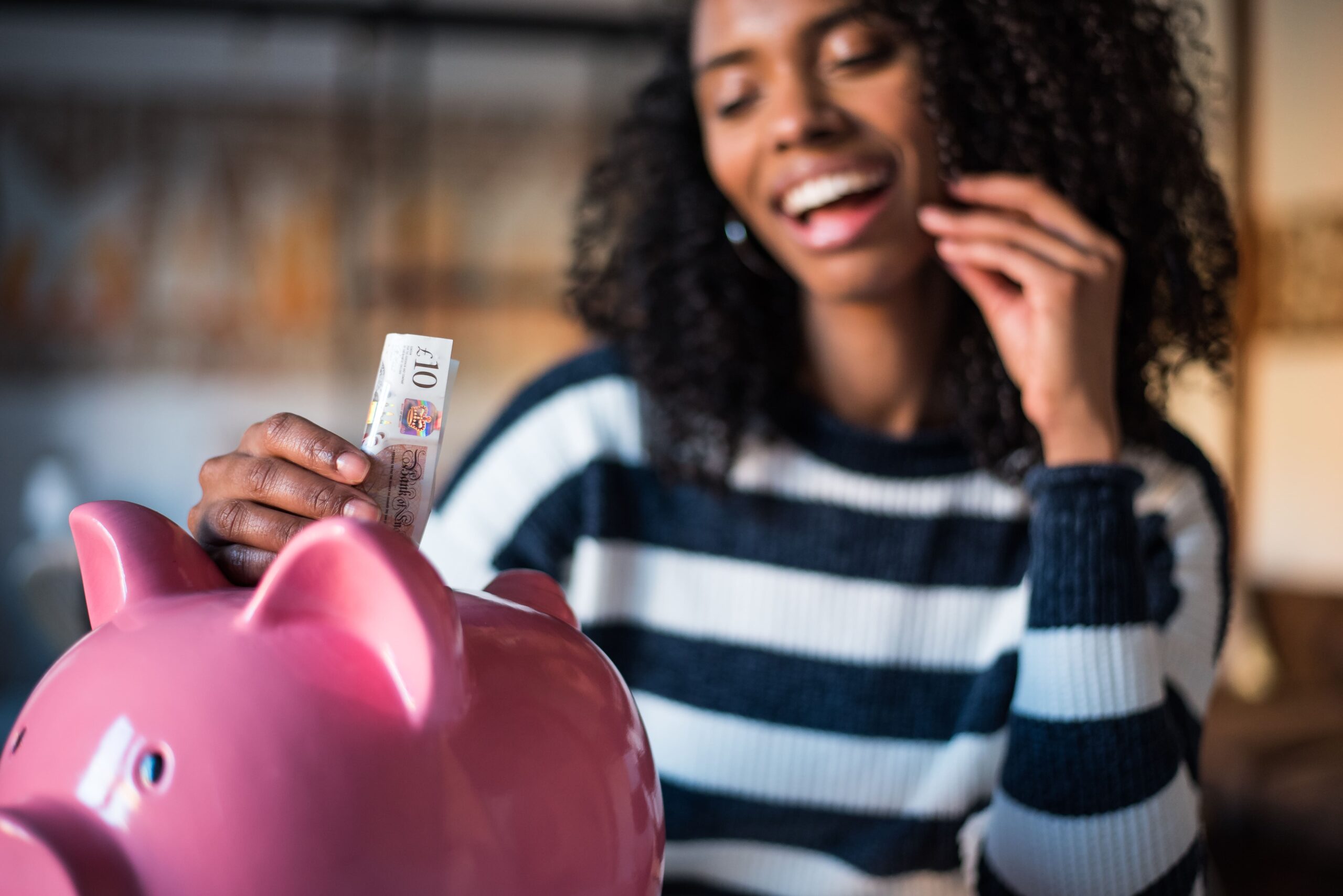 woman saving money with piggy bank