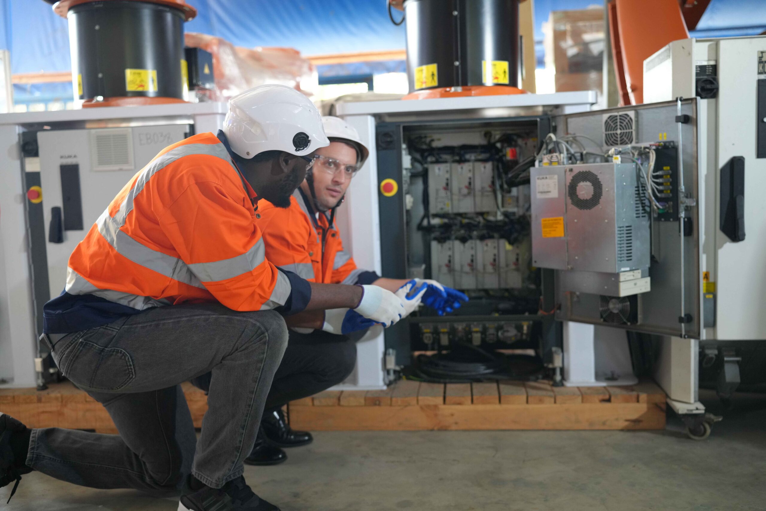 electrical technician checking a big machinery