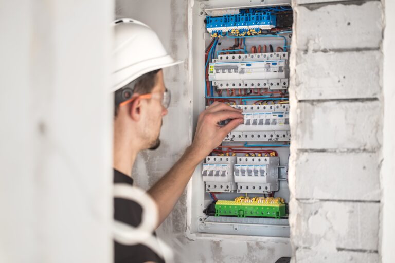 Professional electrician performing a panel upgrade, meticulously working on a residential electrical circuit breaker panel.
