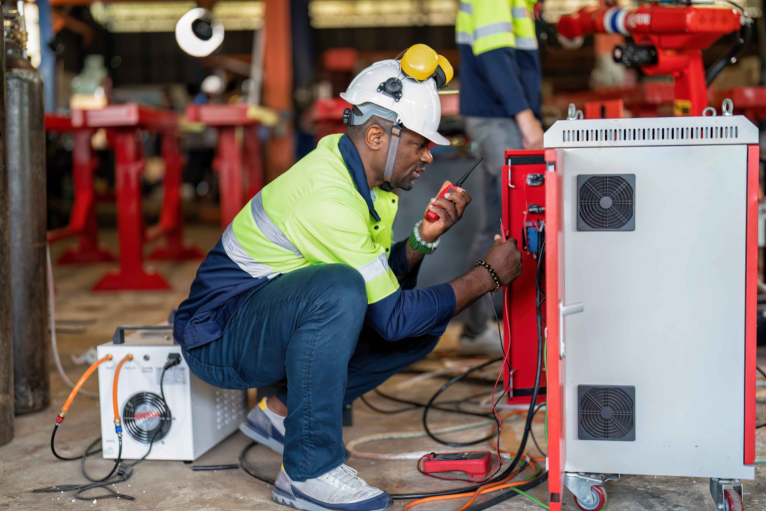 electrician at robot factory measurement