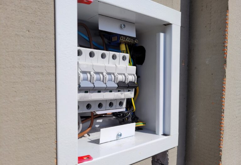 Electricity distribution box with wires and circuit breakers.