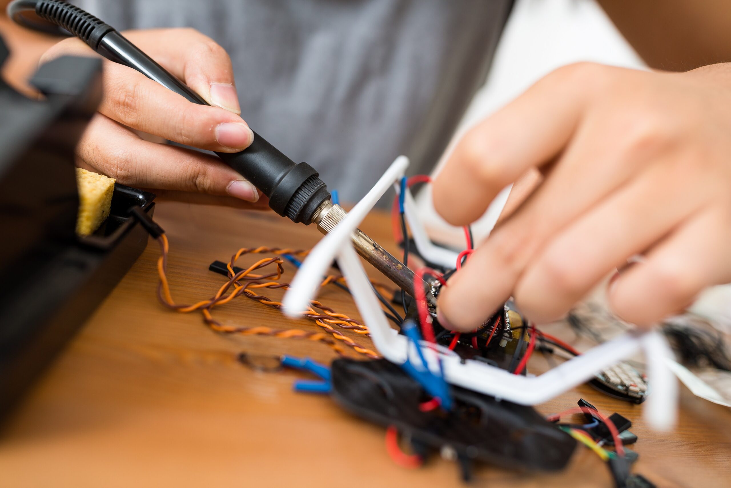 man welding the component for connection of drone